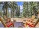 Inviting wooden deck featuring comfortable Adirondack chairs, ideal for relaxing outdoors at 7753 Red Fox Dr, Evergreen, CO 80439