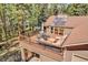 Relax on the elevated deck with a dining table and comfortable outdoor seating at 7753 Red Fox Dr, Evergreen, CO 80439