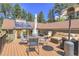 Spacious deck with seating area, dining area, and views of the surrounding landscape at 7753 Red Fox Dr, Evergreen, CO 80439