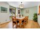 A spacious dining room with hardwood floors, a wooden table, and a large window with views of the outdoors at 7753 Red Fox Dr, Evergreen, CO 80439