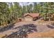 Charming single-Gathering home with a two-car garage nestled amongst mature pine trees at 7753 Red Fox Dr, Evergreen, CO 80439