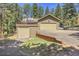 Spacious three-car garage with possible rooftop deck, side parking and exterior in a wooded location at 7753 Red Fox Dr, Evergreen, CO 80439