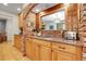 Kitchen showcasing granite countertops, updated appliances, and exposed brick elements at 7753 Red Fox Dr, Evergreen, CO 80439
