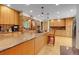 Modern kitchen with a large center island, wooden cabinets, and stainless-steel appliances at 7753 Red Fox Dr, Evergreen, CO 80439