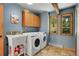 Well-equipped laundry room featuring a washer and dryer, a utility sink, and ample storage space at 7753 Red Fox Dr, Evergreen, CO 80439
