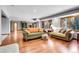 Inviting living room featuring hardwood floors, a cozy fireplace, and ample seating for relaxing and entertaining at 7753 Red Fox Dr, Evergreen, CO 80439