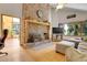 Inviting living room featuring a brick fireplace, wood floors, and ample natural light at 7753 Red Fox Dr, Evergreen, CO 80439