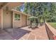 Patio with dining table and lounge seating surrounded by mature pine trees at 7753 Red Fox Dr, Evergreen, CO 80439