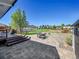 Well-manicured outdoor space with a wooden deck, patio with table set and landscape features at 7809 S Flower St, Littleton, CO 80128