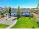 Backyard view of the home with deck and patio, surrounded by a well-maintained lawn, perfect for outdoor enjoyment at 7809 S Flower St, Littleton, CO 80128
