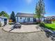 Charming backyard with patio, dining set, shed, and deck, ideal for outdoor living and entertaining at 7809 S Flower St, Littleton, CO 80128