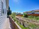 Backyard view from a wooden deck, showcasing a natural area, a blue sky and neighborhood houses at 7809 S Flower St, Littleton, CO 80128