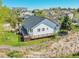 Backyard view showcasing a deck with wood finish and mature trees, offering privacy and a natural setting at 7809 S Flower St, Littleton, CO 80128