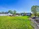 Expansive backyard featuring lush green grass, a beautiful garden, and a charming white picket fence at 7809 S Flower St, Littleton, CO 80128