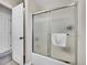 Clean bathroom with glass shower doors and modern towel rack at 7809 S Flower St, Littleton, CO 80128