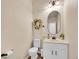 Neutral powder room featuring a stylish mirror and modern fixtures at 7809 S Flower St, Littleton, CO 80128