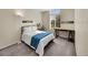 Bright bedroom with arched window, neutral colors, and natural light at 7809 S Flower St, Littleton, CO 80128