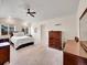 Bright bedroom with a ceiling fan, large windows and wood furniture at 7809 S Flower St, Littleton, CO 80128