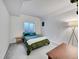 Simple bedroom with a comfortable bed and a window offering natural light at 7809 S Flower St, Littleton, CO 80128