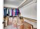Walk-in closet with clothing rack, shelves and ample storage with cardboard boxes at 7809 S Flower St, Littleton, CO 80128