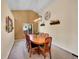 Cozy dining room with vaulted ceiling and traditional wooden furniture at 7809 S Flower St, Littleton, CO 80128