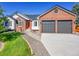 Charming two-story brick home featuring manicured front yard and two-car garage at 7809 S Flower St, Littleton, CO 80128