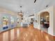Open concept kitchen features white cabinetry, a center island, and hardwood flooring at 7809 S Flower St, Littleton, CO 80128