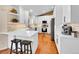 Bright kitchen features a breakfast bar, stainless steel appliances, and white cabinets at 7809 S Flower St, Littleton, CO 80128