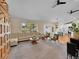 Spacious living room with a large window, vaulted ceilings, and a clear view into the kitchen at 7809 S Flower St, Littleton, CO 80128