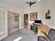 Well-lit home office featuring a vaulted ceiling, and double doors opening to another room at 7809 S Flower St, Littleton, CO 80128