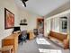 Bright office space with a vaulted ceiling, a large window, and dual desks at 7809 S Flower St, Littleton, CO 80128