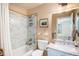 Cozy bathroom featuring tiled shower, neutral colors, modern fixtures, and a vanity with marble countertop at 8300 Fairmount Dr # M103, Denver, CO 80247