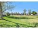 Well-maintained community park with lush green grass, mature trees, and colorful playground equipment, great for outdoor activities at 8300 Fairmount Dr # M103, Denver, CO 80247