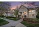 Charming home exterior featuring a well-maintained lawn and inviting front porch at dusk at 8300 Fairmount Dr # M103, Denver, CO 80247