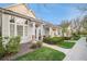 Well-manicured home exterior with a tidy lawn, inviting walkway, and a view of the porch at 8300 Fairmount Dr # M103, Denver, CO 80247