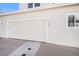 Two car garage of this home with modern lighting and well maintained exterior, perfect for secure parking and storage at 8300 Fairmount Dr # M103, Denver, CO 80247