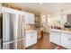 Modern kitchen with stainless steel appliances, white cabinetry, and open access to other rooms at 8300 Fairmount Dr # M103, Denver, CO 80247