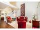 Cozy living room area with a staircase, comfortable seating, and a decorative wall tapestry at 8300 Fairmount Dr # M103, Denver, CO 80247