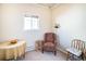 Bright living space with carpet, featuring a window that floods the room with natural light, complemented by cozy seating at 8300 Fairmount Dr # M103, Denver, CO 80247