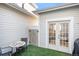 Charming patio with artificial turf, featuring outdoor seating, a table with a mosaic top, and convenient access to the house at 8300 Fairmount Dr # M103, Denver, CO 80247