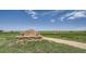 Cherry Creek State Park's stone and wooden West Entrance sign with a picturesque field backdrop at 7724 S Cherokee Trl, Centennial, CO 80016