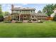 Expansive backyard with a well-manicured lawn, patio, pergola, and solar panels on this inviting home at 1892 W Kettle Ave, Littleton, CO 80120