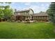 Spacious backyard featuring a lush lawn, a covered patio area, and mature trees, offering a private retreat at 1892 W Kettle Ave, Littleton, CO 80120
