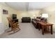 Inviting basement featuring two sofas, a TV, and cozy rocking chair; great for entertaining at 1892 W Kettle Ave, Littleton, CO 80120