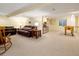Spacious basement with a foosball table, sofa, and additional seating, creating an entertainment zone at 1892 W Kettle Ave, Littleton, CO 80120