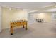 Basement with a foosball table and seating area, perfect for leisure activities and gatherings at 1892 W Kettle Ave, Littleton, CO 80120