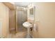 Stylish bathroom with a pedestal sink, glass-enclosed shower, and neutral decor at 1892 W Kettle Ave, Littleton, CO 80120
