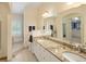 Main bathroom features dual sinks, granite countertops, plantation shutters, and natural light at 1892 W Kettle Ave, Littleton, CO 80120