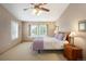 Cozy main bedroom with carpet, ceiling fan, plantation shutters, and plenty of natural light at 1892 W Kettle Ave, Littleton, CO 80120