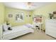 Bright bedroom with a white bed, desk, and dresser, featuring a ceiling fan and shuttered window at 1892 W Kettle Ave, Littleton, CO 80120